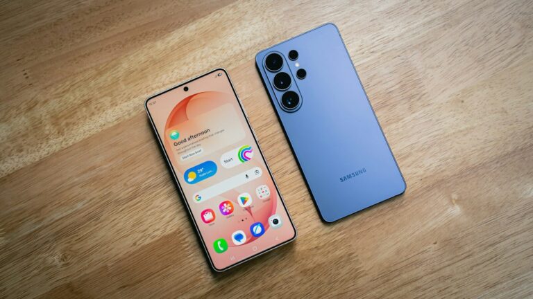 Two smartphones displayed on a wooden surface
